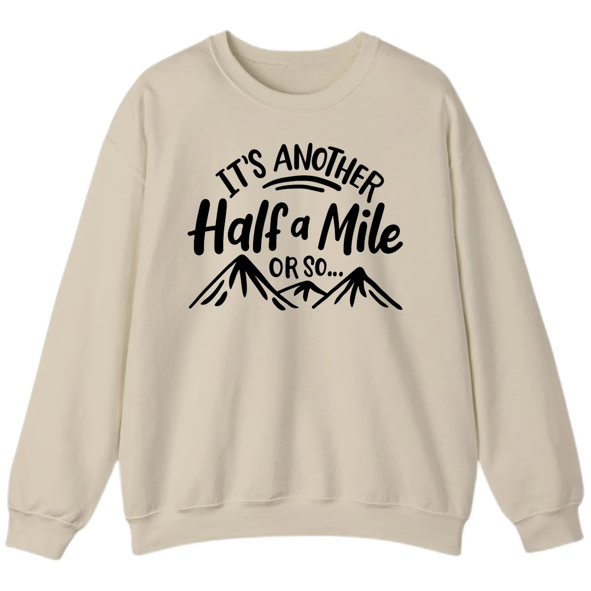 White text reading 'It's Another Half a Mile Or So...' with illustrated snow-capped mountains below on gray background in Sand