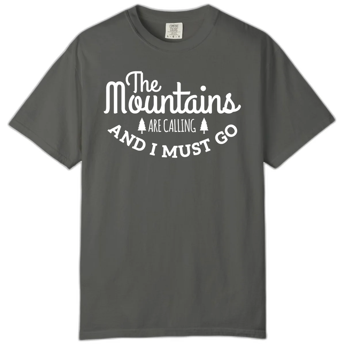 White text reading "The Mountains Are Calling And I Must Go" with pine trees on gray background in Pepper