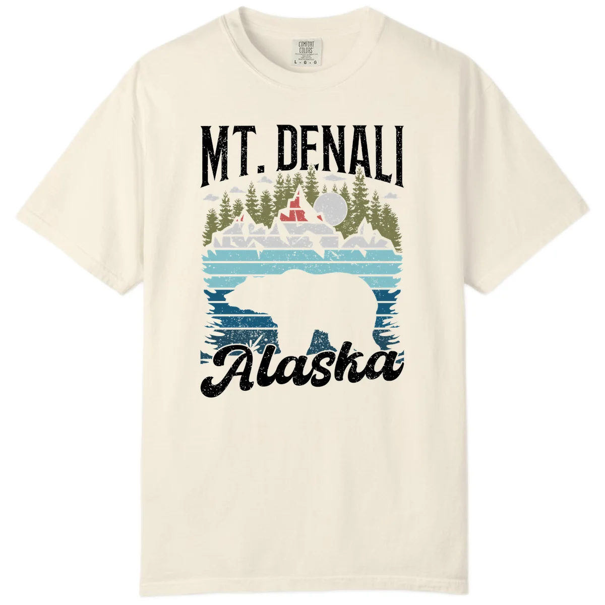 Denali bear Alaska design: layered illustration with silhouetted bear emerging from water, mountain peaks, fortress, forest, and full moon. in Ivory