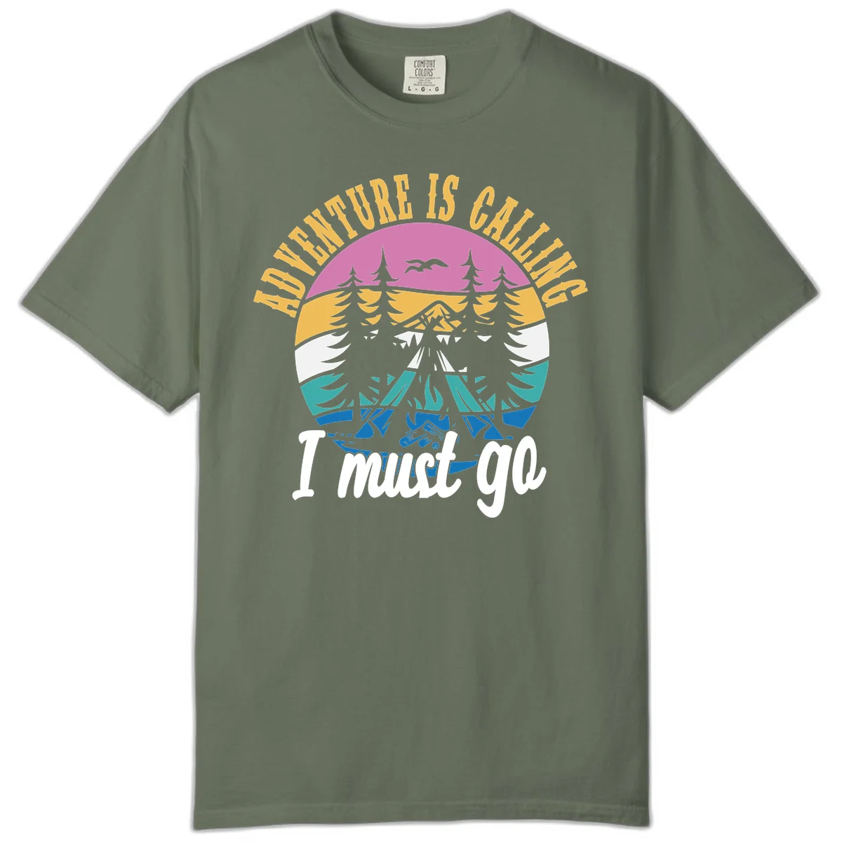 Circular badge with mountain landscape, evergreen trees, and flying birds in pink, gold, white, teal and blue with text 'Adventure Is Calling I Must Go' in Moss