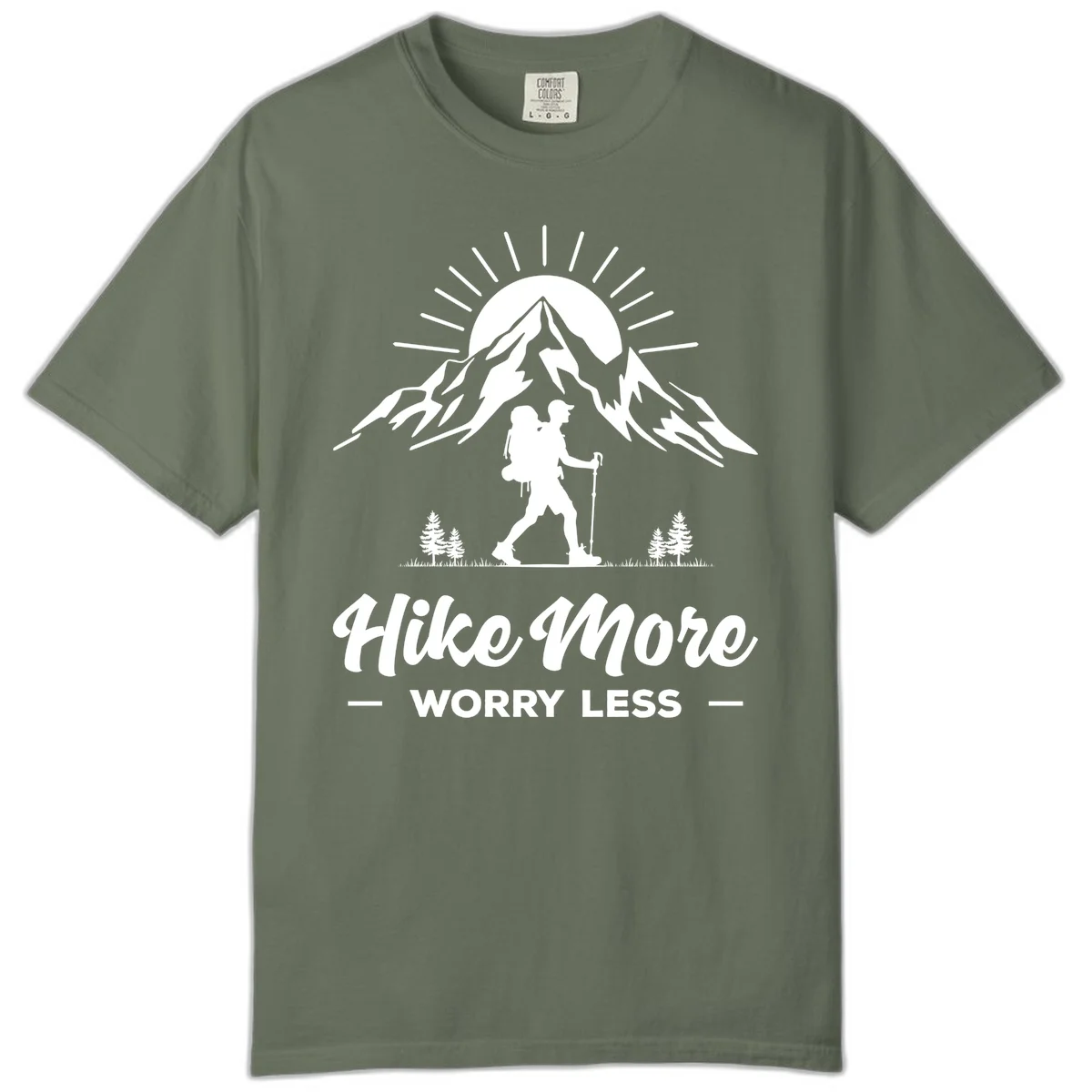 Silhouette of hiker with backpack and poles facing snow-capped mountain with radiating sun, evergreen trees below, text reads 'Hike More Worry Less' in Moss