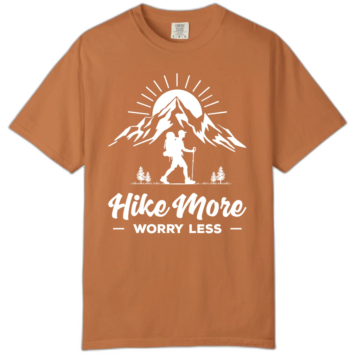 Silhouette of hiker with backpack and poles facing snow-capped mountain with radiating sun, evergreen trees below, text reads 'Hike More Worry Less' in Yam