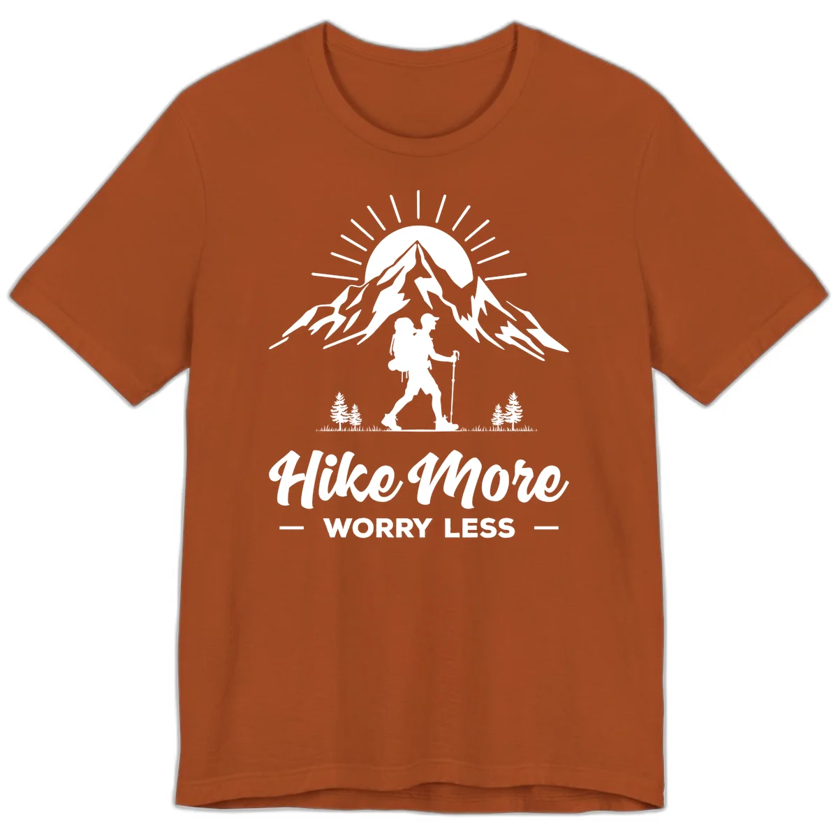 Silhouette of hiker with backpack and poles facing snow-capped mountain with radiating sun, evergreen trees below, text reads 'Hike More Worry Less' in Autumn