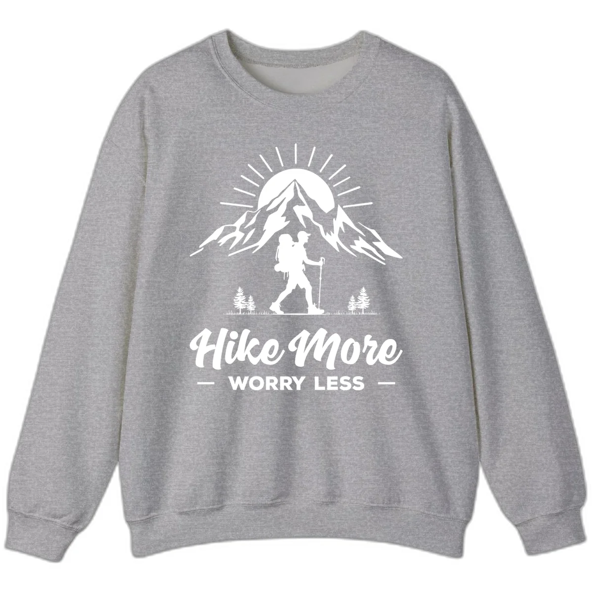 Silhouette of hiker with backpack and poles facing snow-capped mountain with radiating sun, evergreen trees below, text reads 'Hike More Worry Less' in Sport Grey
