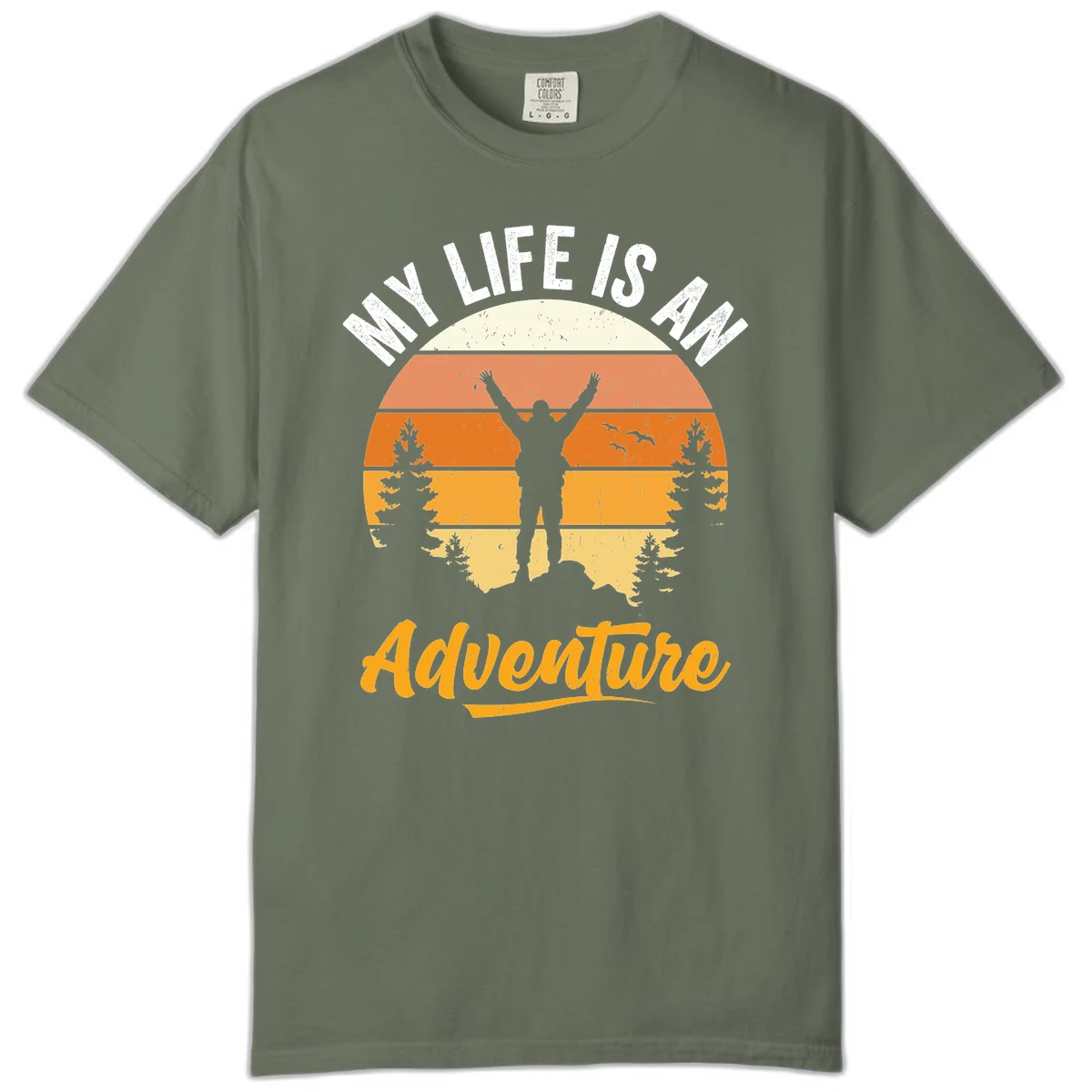Retro sunset illustration with silhouette of person celebrating arms raised, evergreen trees and mountains, text 'My Life Is An Adventure' in Moss