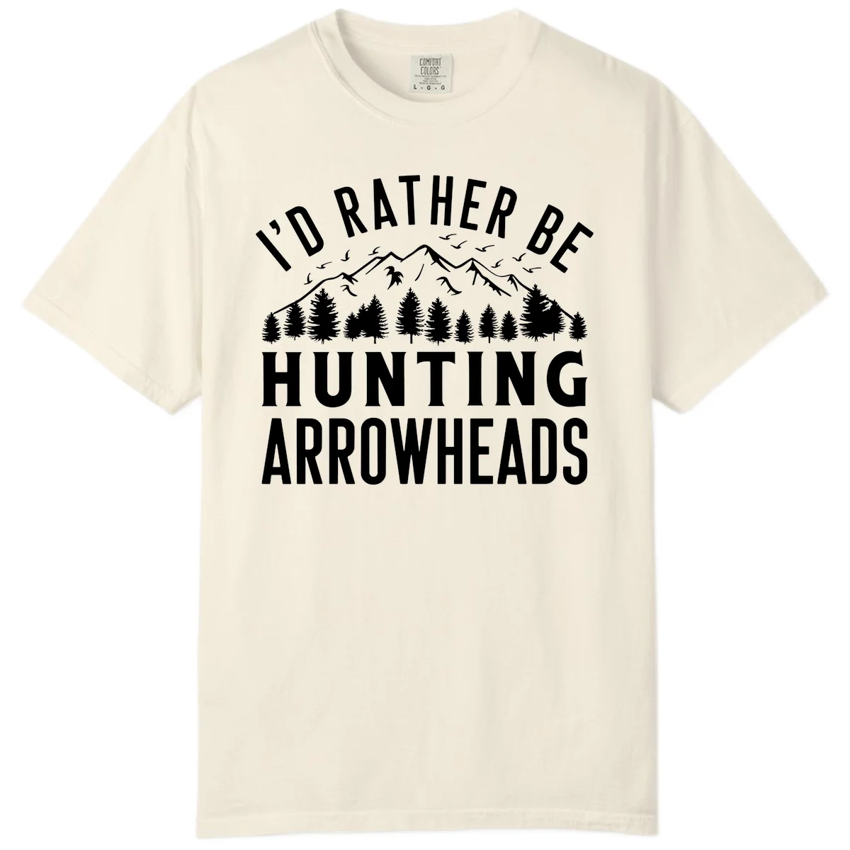 Mountain landscape with evergreen trees and birds, white text reading 'I'd Rather Be Hunting Arrowheads' on gray background in Ivory