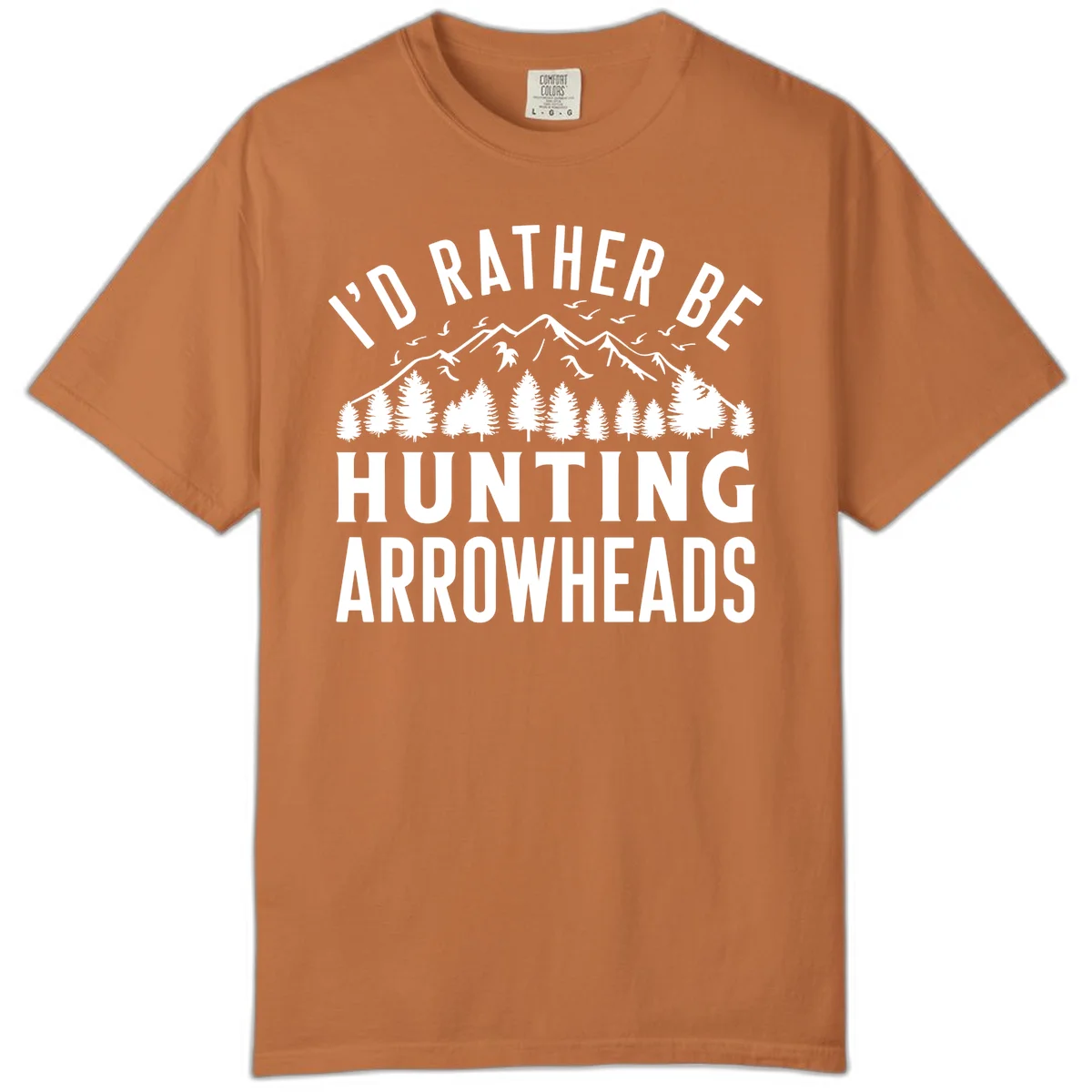 Mountain landscape with evergreen trees and birds, white text reading 'I'd Rather Be Hunting Arrowheads' on gray background in Yam