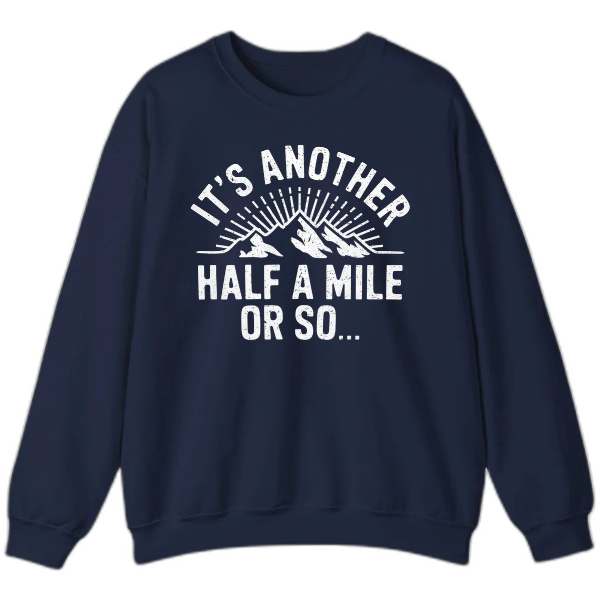 Retro distressed design with mountain peaks and sun rays, text reads 'It's Another Half A Mile Or So' - humorous hiking and camping artwork in Navy