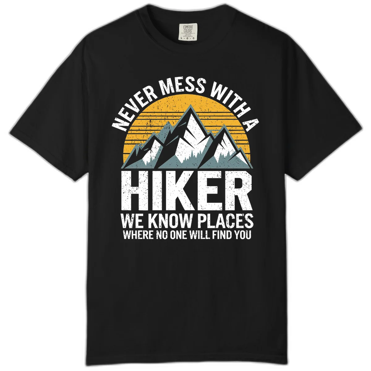 Vintage-style design with snow-capped mountains and forest silhouette against striped sunset, text reads 'Never Mess With A Hiker We Know Places Where No One Will Find You' in Black