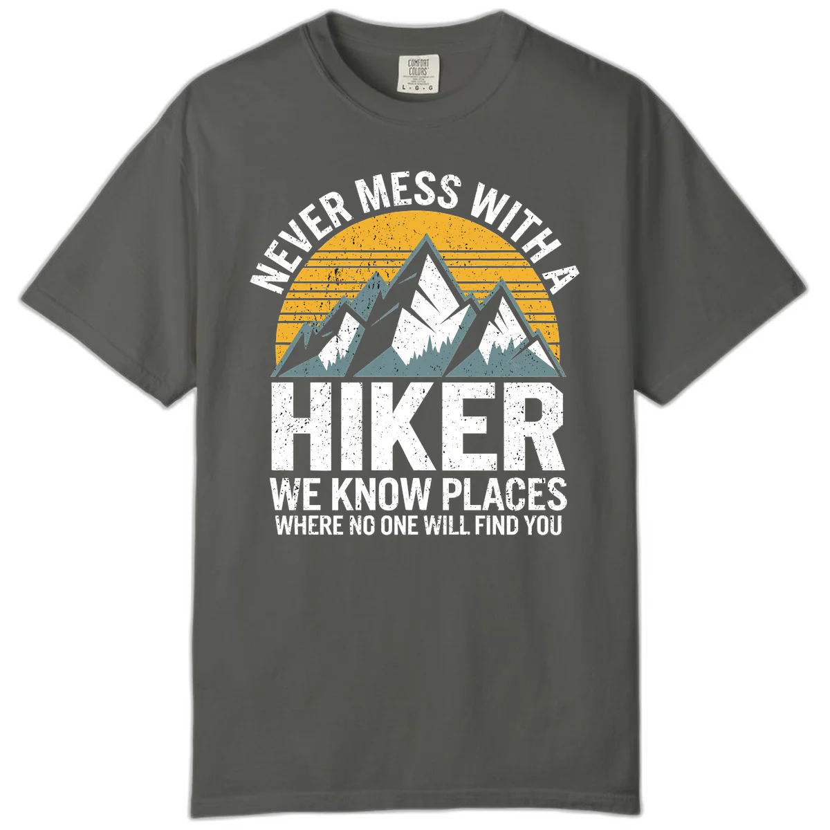 Vintage-style design with snow-capped mountains and forest silhouette against striped sunset, text reads 'Never Mess With A Hiker We Know Places Where No One Will Find You' in Pepper