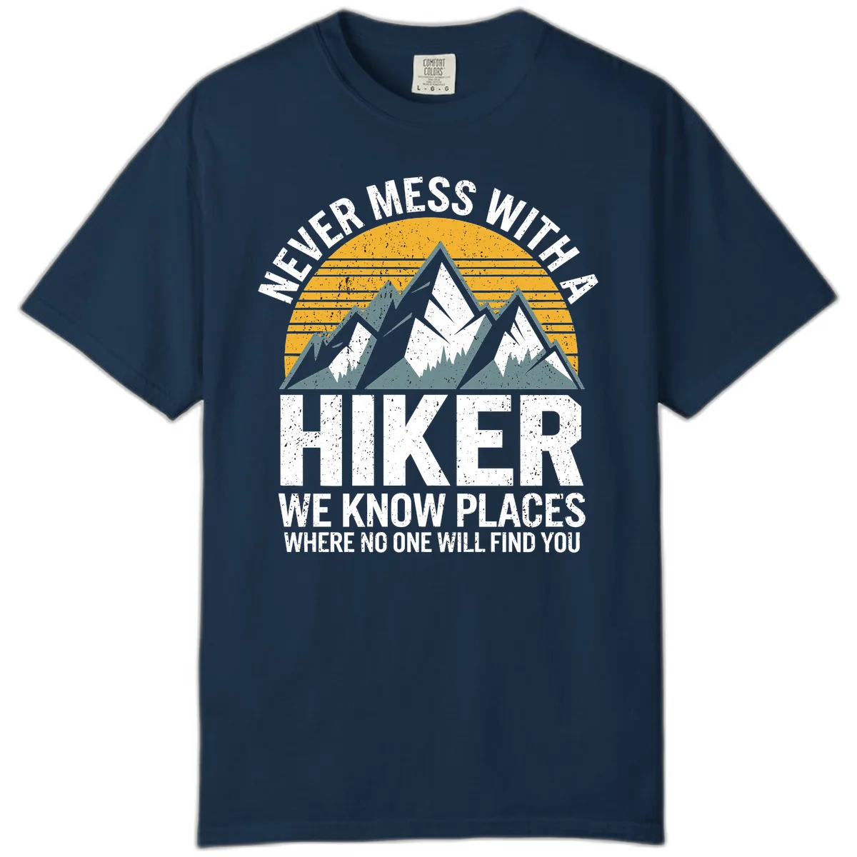 Vintage-style design with snow-capped mountains and forest silhouette against striped sunset, text reads 'Never Mess With A Hiker We Know Places Where No One Will Find You' in True Navy