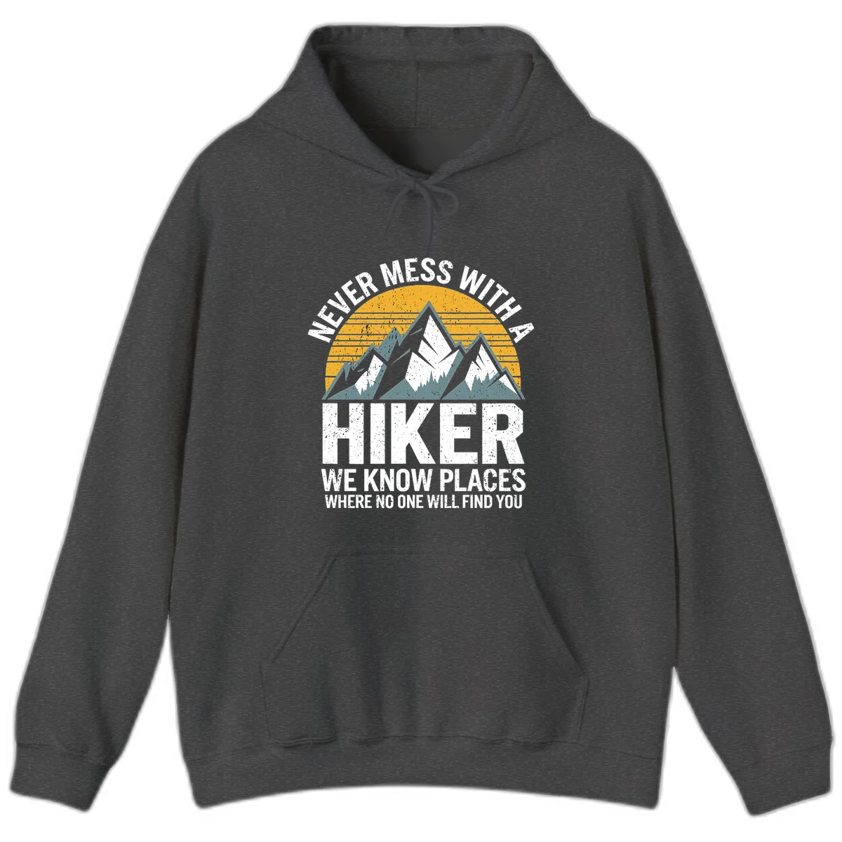 Vintage-style design with snow-capped mountains and forest silhouette against striped sunset, text reads 'Never Mess With A Hiker We Know Places Where No One Will Find You' in Dark Heather