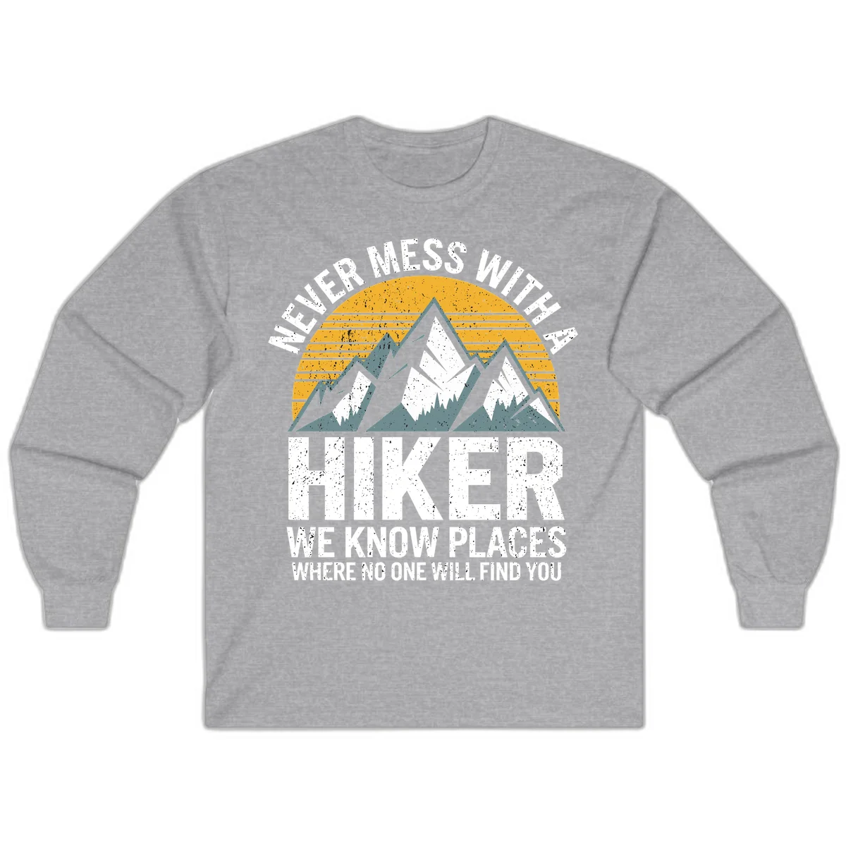 Vintage-style design with snow-capped mountains and forest silhouette against striped sunset, text reads 'Never Mess With A Hiker We Know Places Where No One Will Find You' in Sport Grey