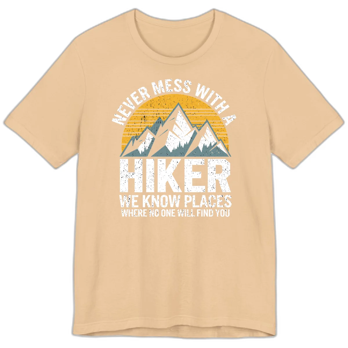 Vintage-style design with snow-capped mountains and forest silhouette against striped sunset, text reads 'Never Mess With A Hiker We Know Places Where No One Will Find You' in Sand Dune