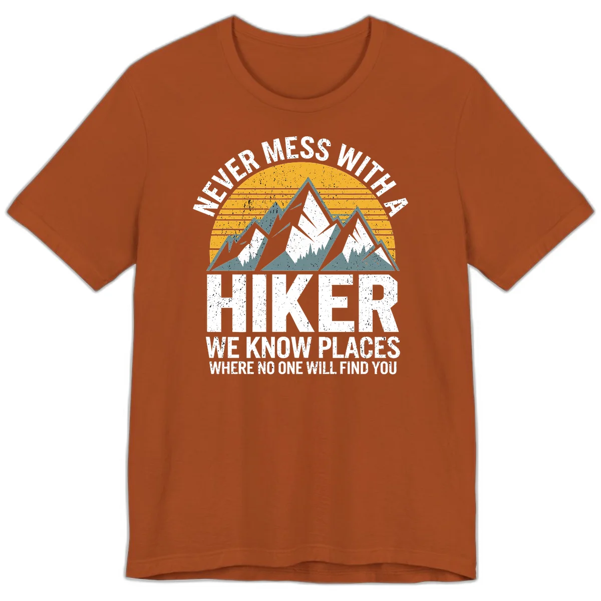 Vintage-style design with snow-capped mountains and forest silhouette against striped sunset, text reads 'Never Mess With A Hiker We Know Places Where No One Will Find You' in Autumn