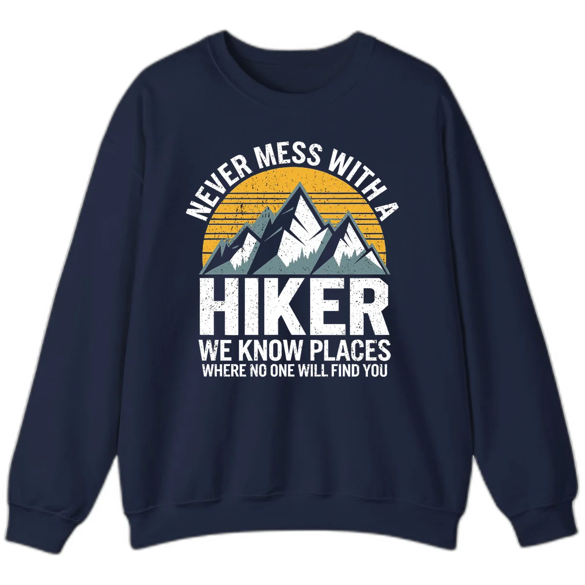 Vintage-style design with snow-capped mountains and forest silhouette against striped sunset, text reads 'Never Mess With A Hiker We Know Places Where No One Will Find You' in Navy