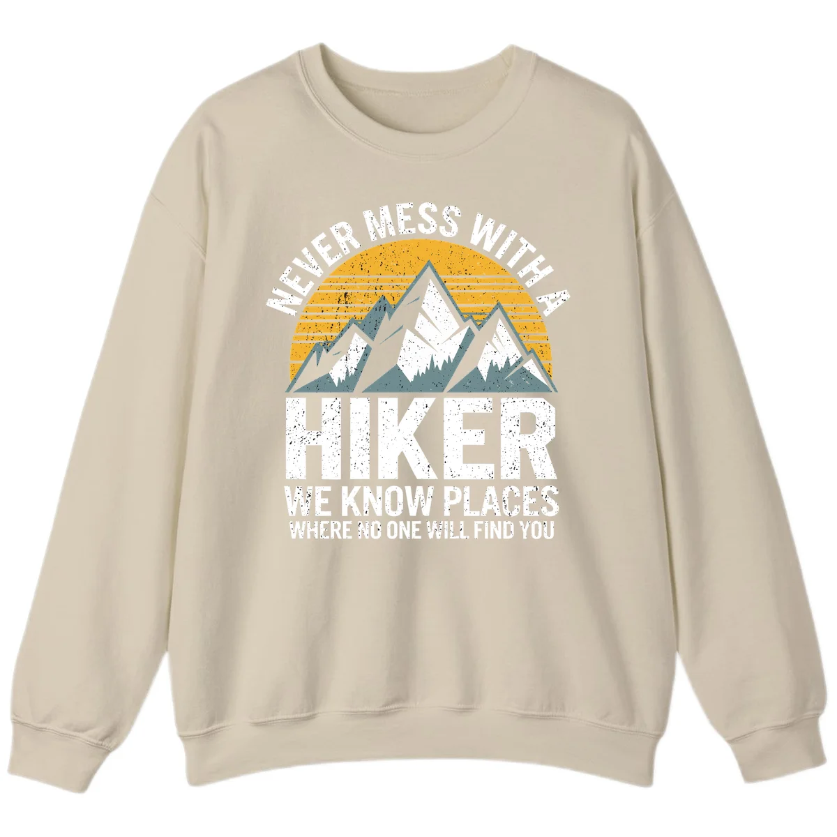 Vintage-style design with snow-capped mountains and forest silhouette against striped sunset, text reads 'Never Mess With A Hiker We Know Places Where No One Will Find You' in Sand
