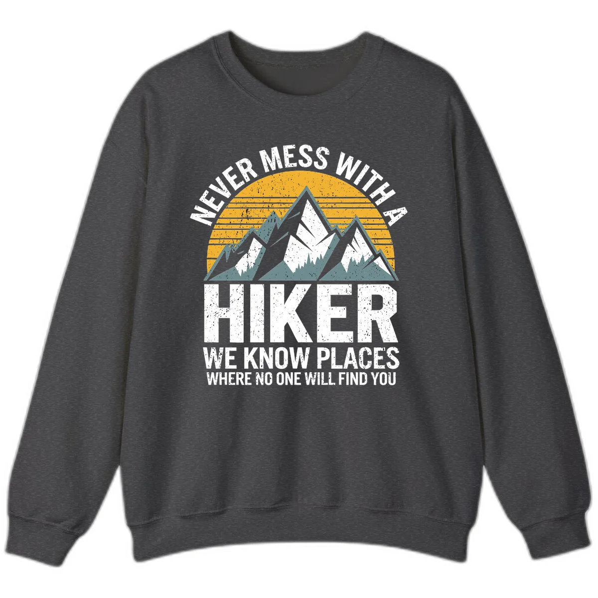Vintage-style design with snow-capped mountains and forest silhouette against striped sunset, text reads 'Never Mess With A Hiker We Know Places Where No One Will Find You' in Dark Heather