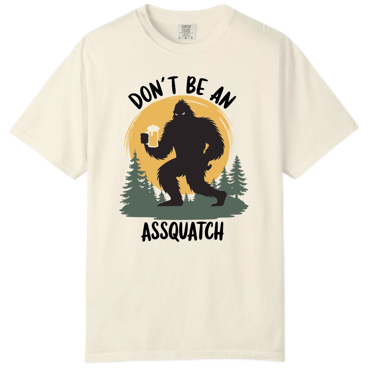 Black silhouette of Bigfoot holding a beer mug under a full moon with pine trees, text reads don't be an assquatch in Ivory