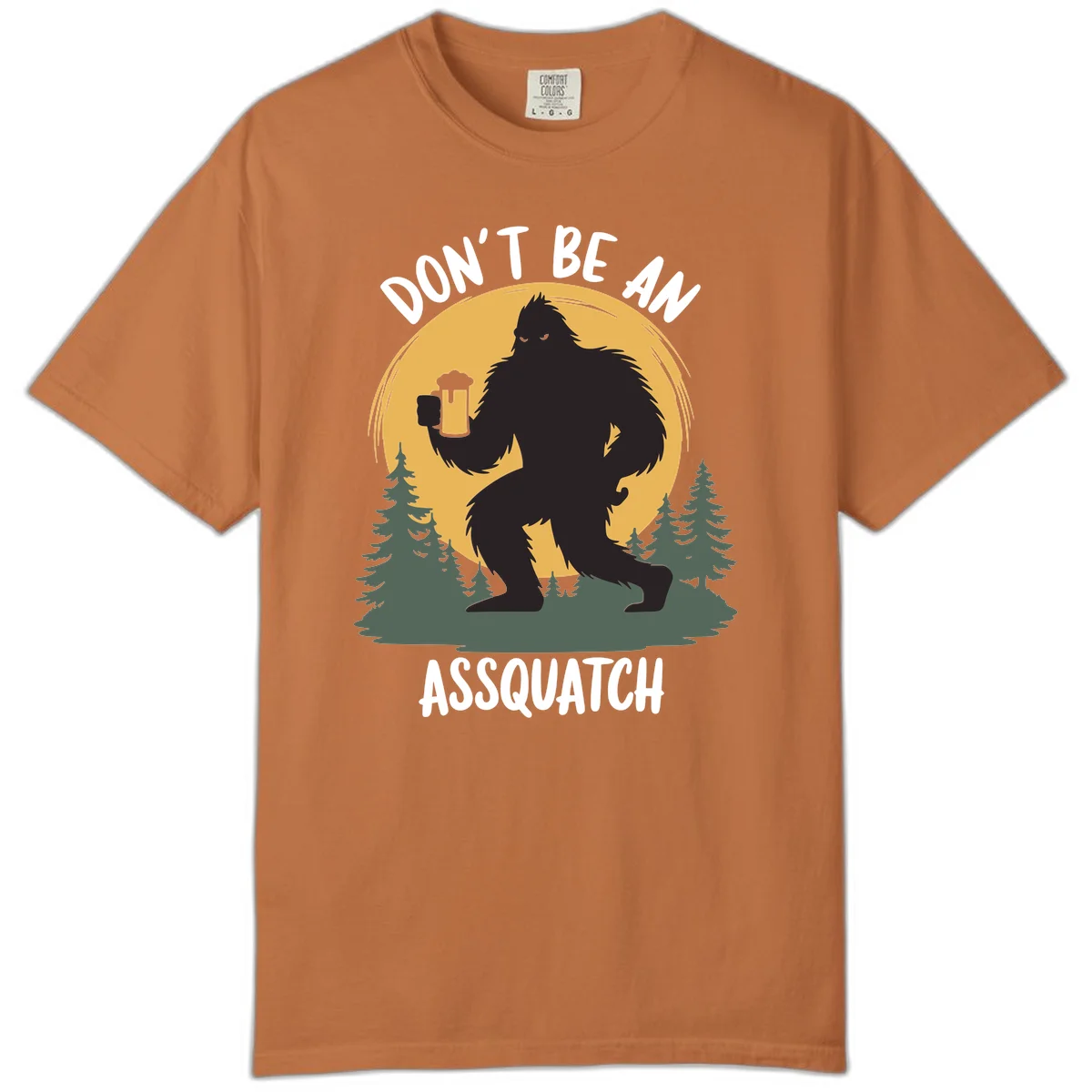 Black silhouette of Bigfoot holding a beer mug under a full moon with pine trees, text reads don't be an assquatch in Yam