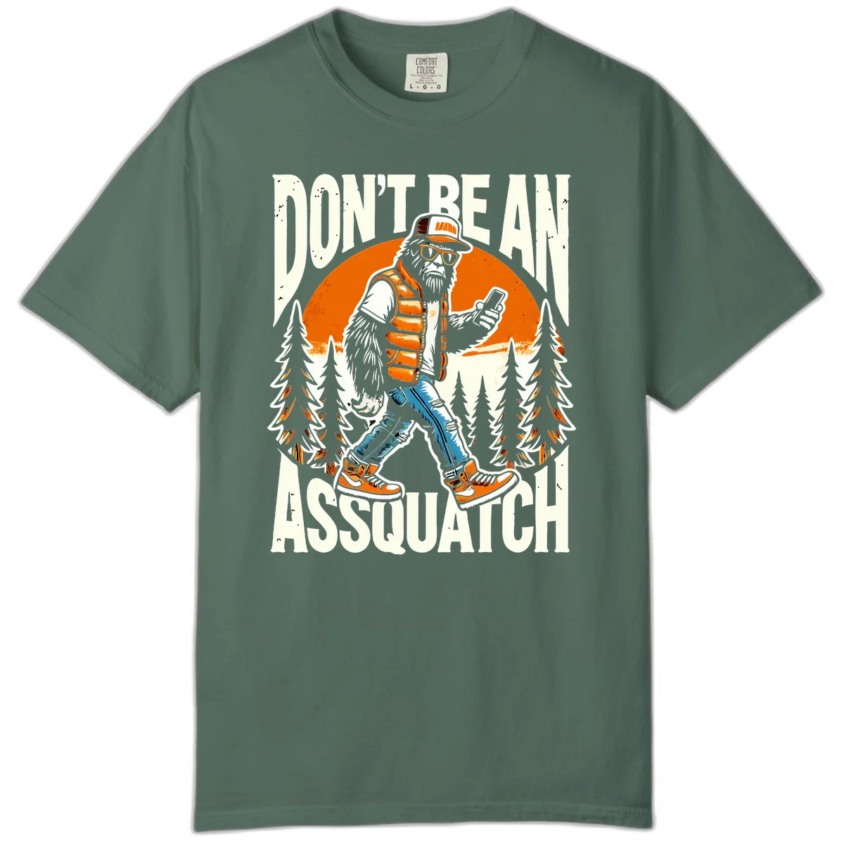 Cartoon sasquatch in hiking gear with backpack and smartphone, 'Don't Be An Assquatch' text, forest and orange sun background. in Blue Spruce