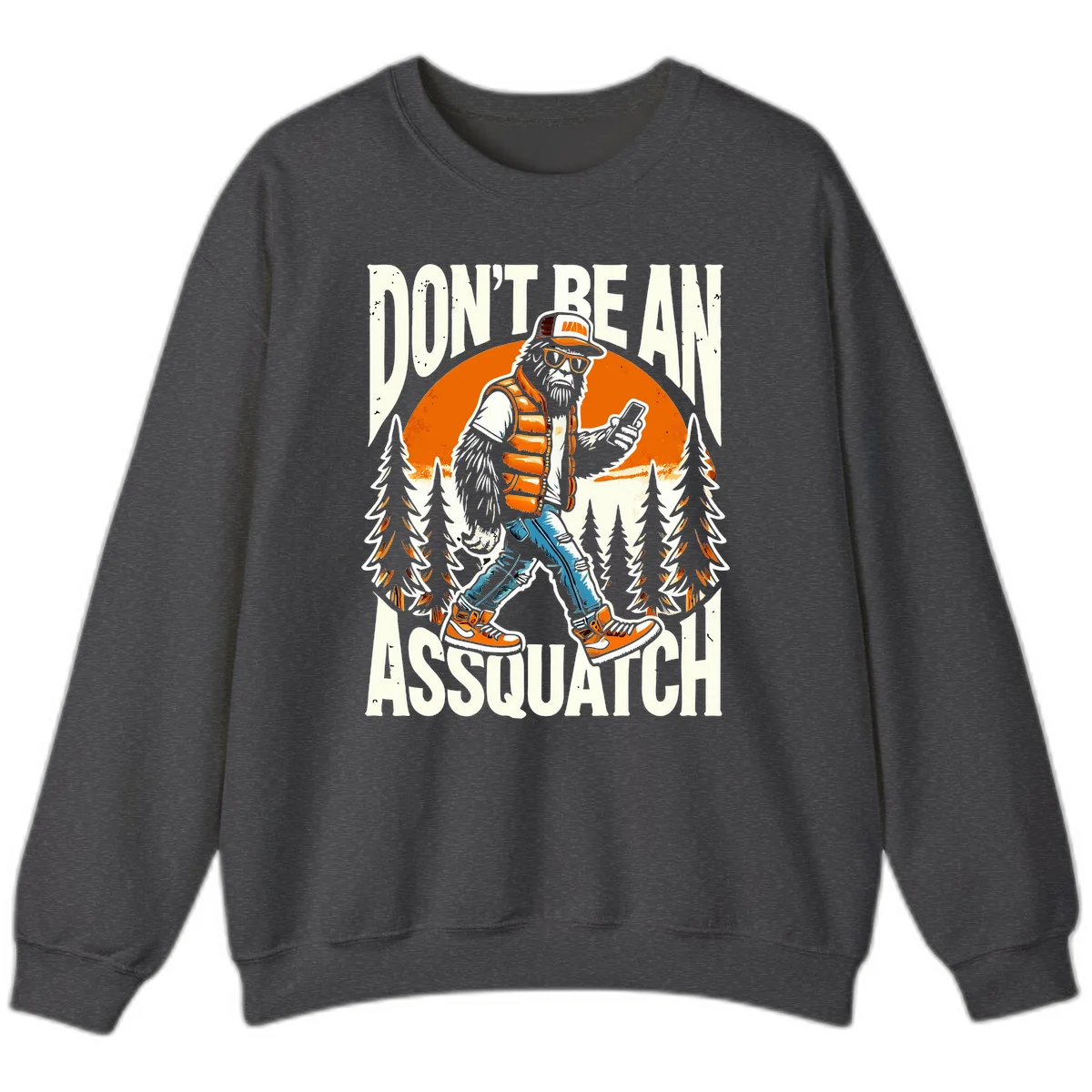 Cartoon sasquatch in hiking gear with backpack and smartphone, 'Don't Be An Assquatch' text, forest and orange sun background. in Dark Heather