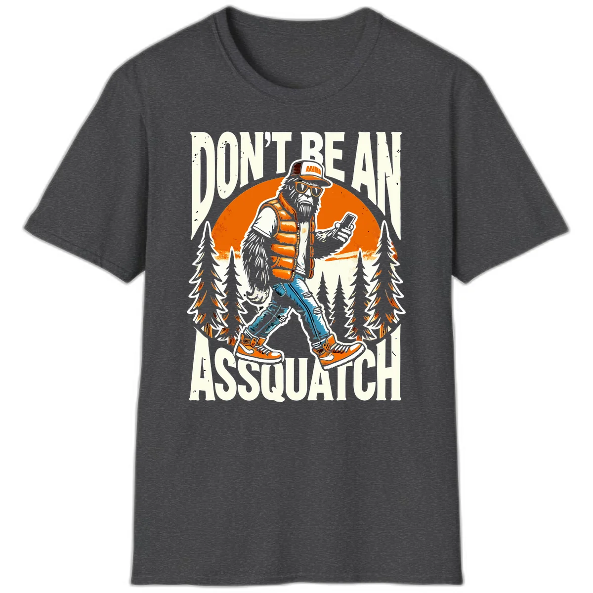 Cartoon sasquatch in hiking gear with backpack and smartphone, 'Don't Be An Assquatch' text, forest and orange sun background. in Dark Heather