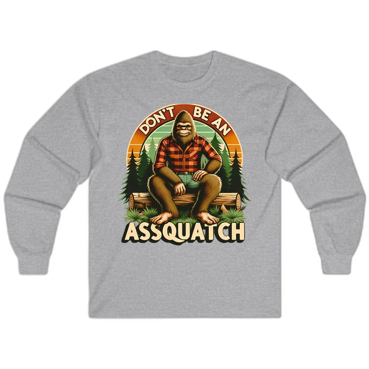 Vintage badge design with friendly Bigfoot in plaid shirt sitting on a log with forest trees, text reads 'Don't Be An Assquatch' in Sport Grey