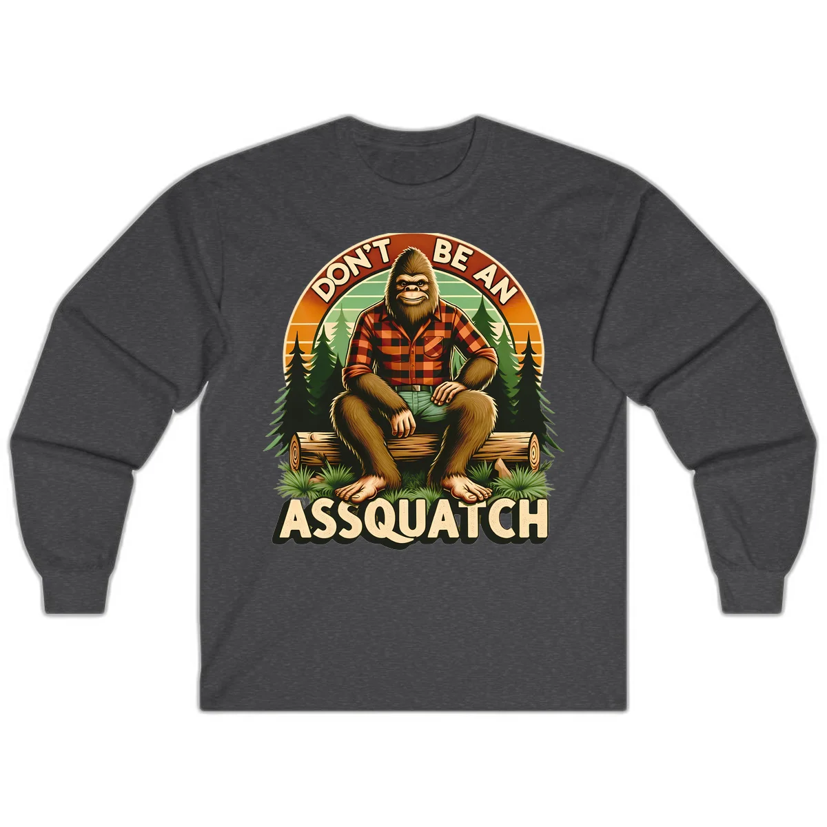 Vintage badge design with friendly Bigfoot in plaid shirt sitting on a log with forest trees, text reads 'Don't Be An Assquatch' in Dark Heather
