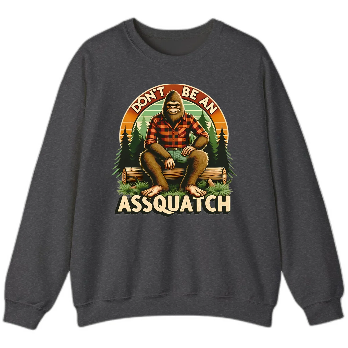 Vintage badge design with friendly Bigfoot in plaid shirt sitting on a log with forest trees, text reads 'Don't Be An Assquatch' in Dark Heather