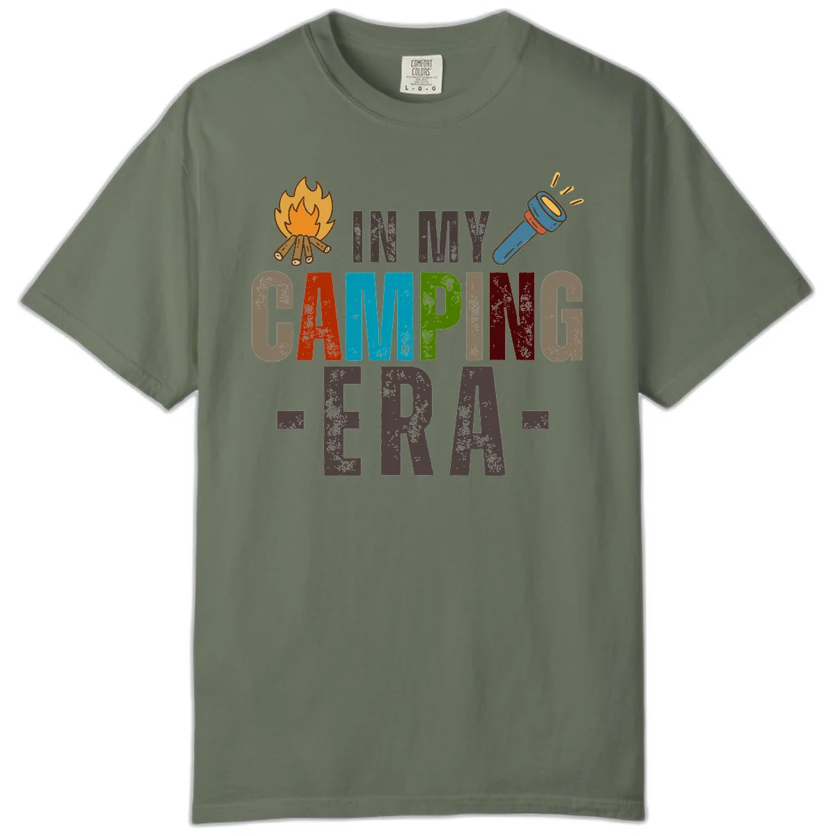 Campfire and flashlight icons flank colorful distressed text reading 'In My Camping Era' on gray background in Moss