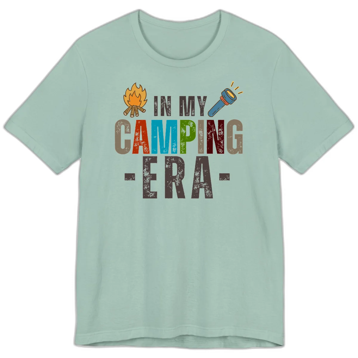 Campfire and flashlight icons flank colorful distressed text reading 'In My Camping Era' on gray background in Dusty Blue