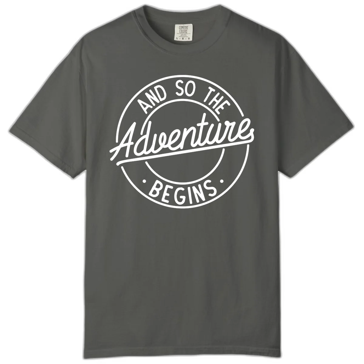 Vintage circular badge design with white text reading 'And So The Adventure Begins' on gray background in Pepper