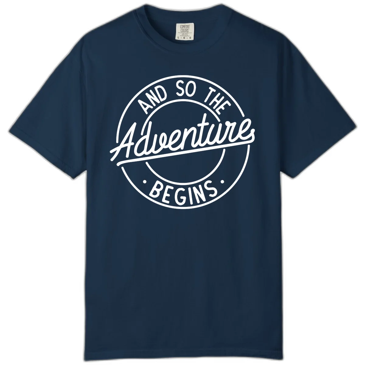 Vintage circular badge design with white text reading 'And So The Adventure Begins' on gray background in True Navy