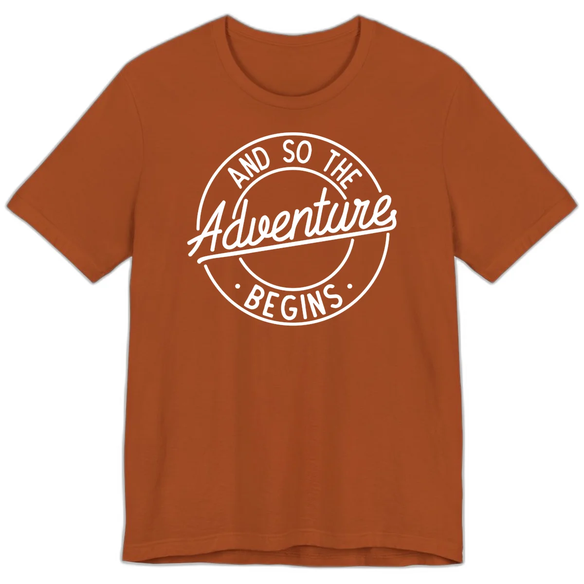 Vintage circular badge design with white text reading 'And So The Adventure Begins' on gray background in Autumn