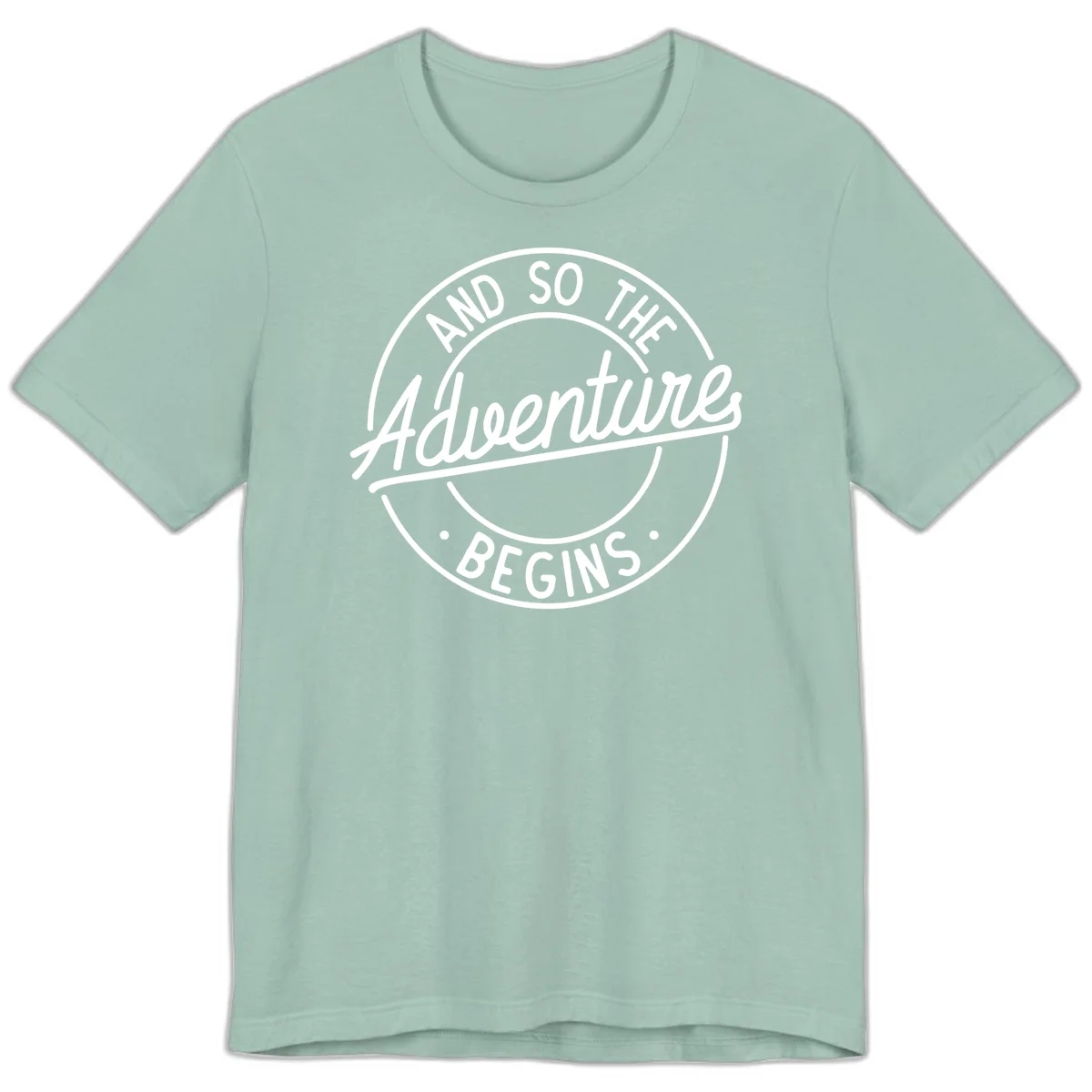 Vintage circular badge design with white text reading 'And So The Adventure Begins' on gray background in Dusty Blue