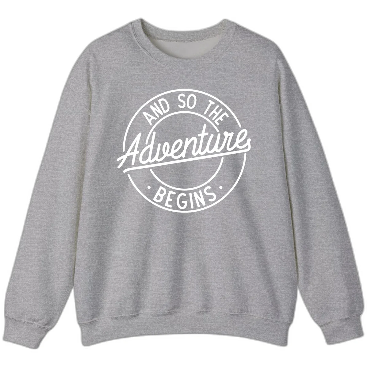 Vintage circular badge design with white text reading 'And So The Adventure Begins' on gray background in Sport Grey