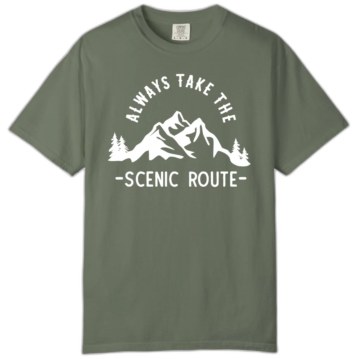 Mountain landscape with evergreen trees and text reading 'Always Take The Scenic Route' in bold lettering in Moss