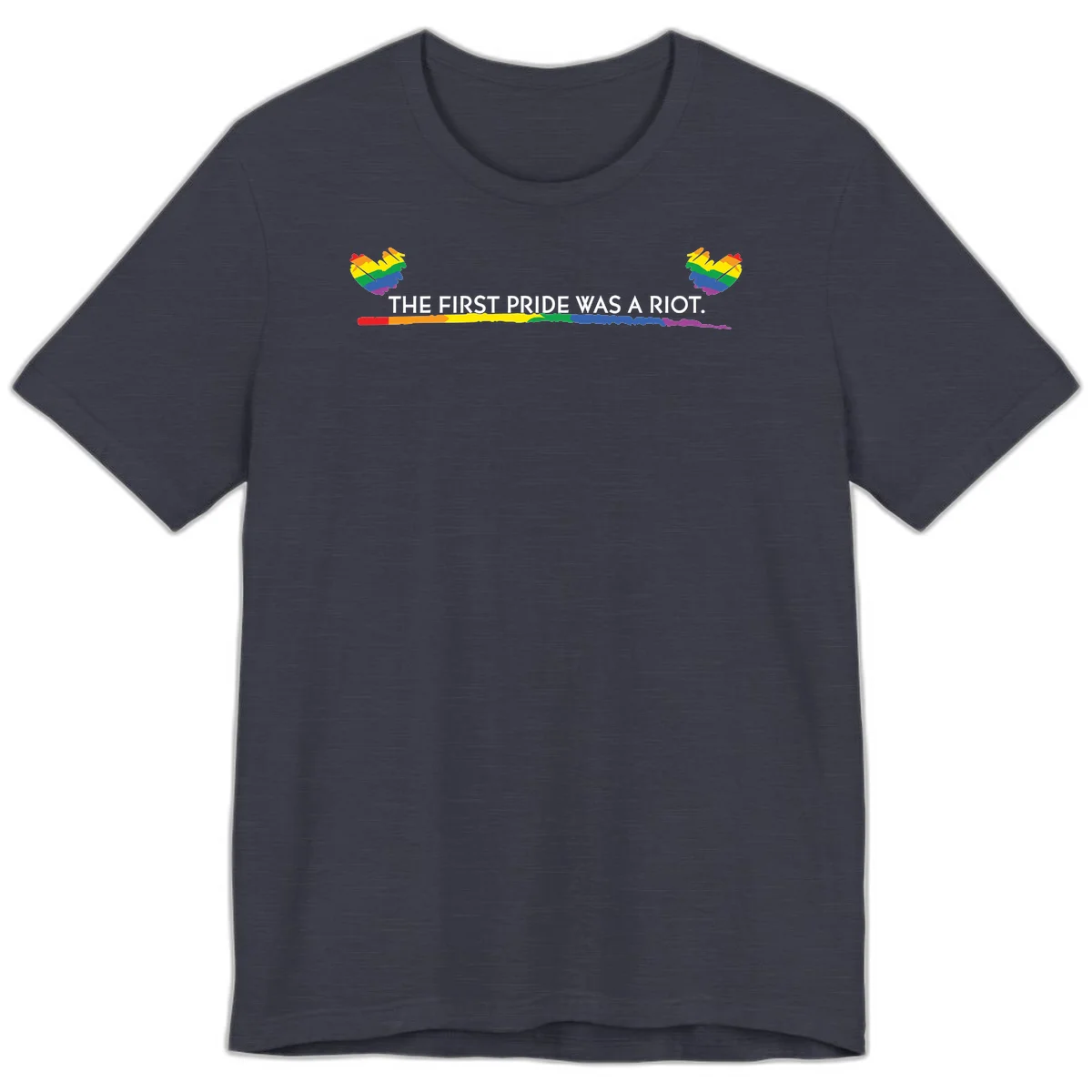 Gray background with white text reading 'THE FIRST PRIDE WAS A RIOT' surrounded by rainbow pride hearts and gradient stripe in Heather Midnight Navy