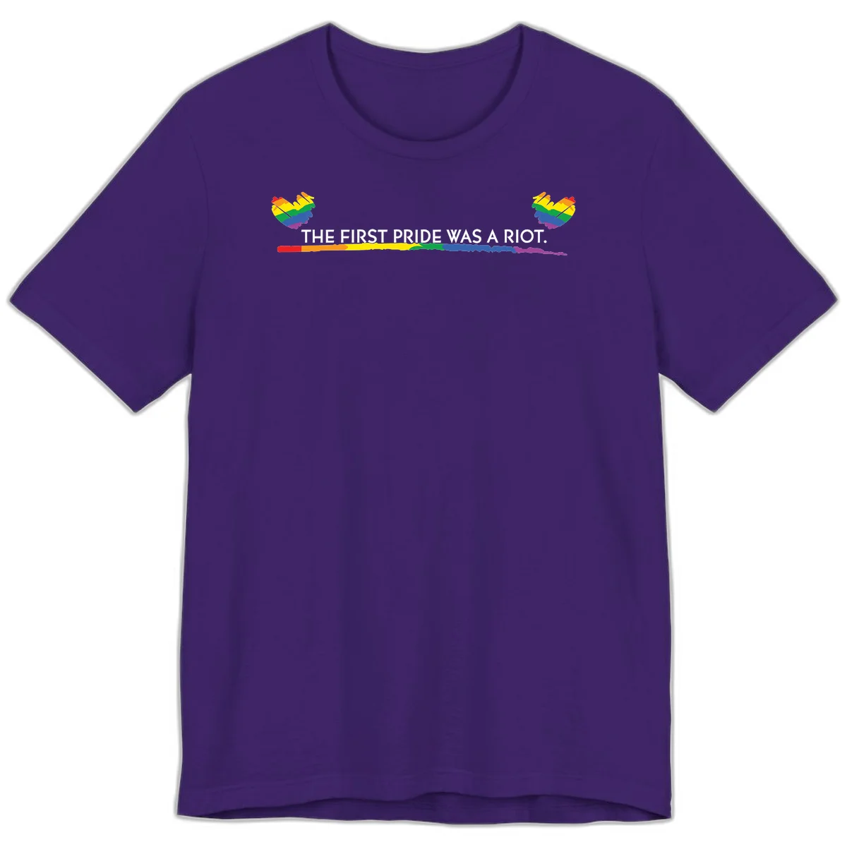 Gray background with white text reading 'THE FIRST PRIDE WAS A RIOT' surrounded by rainbow pride hearts and gradient stripe in Team Purple