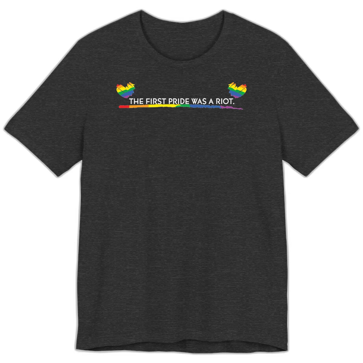 Gray background with white text reading 'THE FIRST PRIDE WAS A RIOT' surrounded by rainbow pride hearts and gradient stripe in Dark Grey Heather