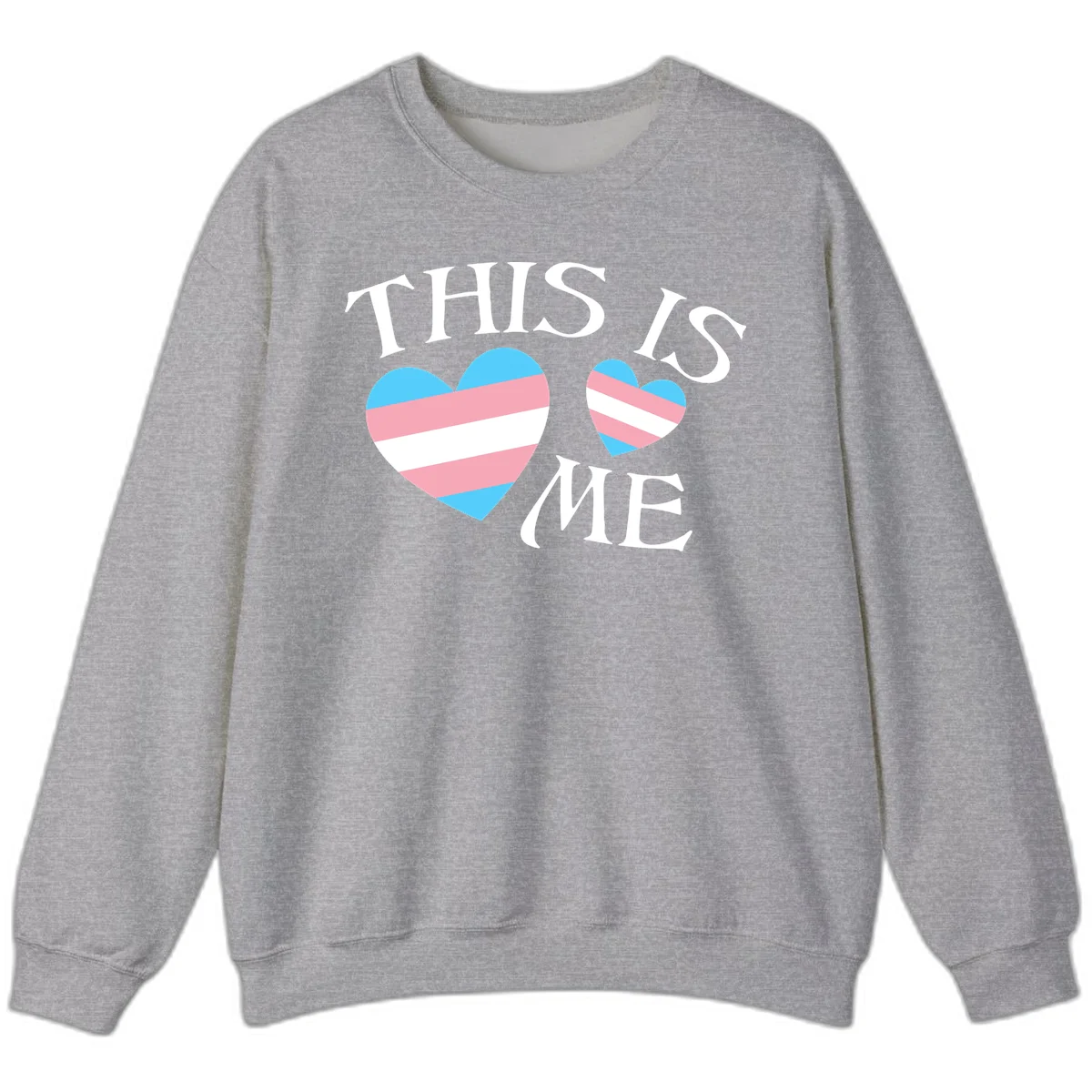 Two striped hearts in trans flag colors (blue, pink, white) with 'THIS IS ME' text celebrating trans pride and identity in Sport Grey