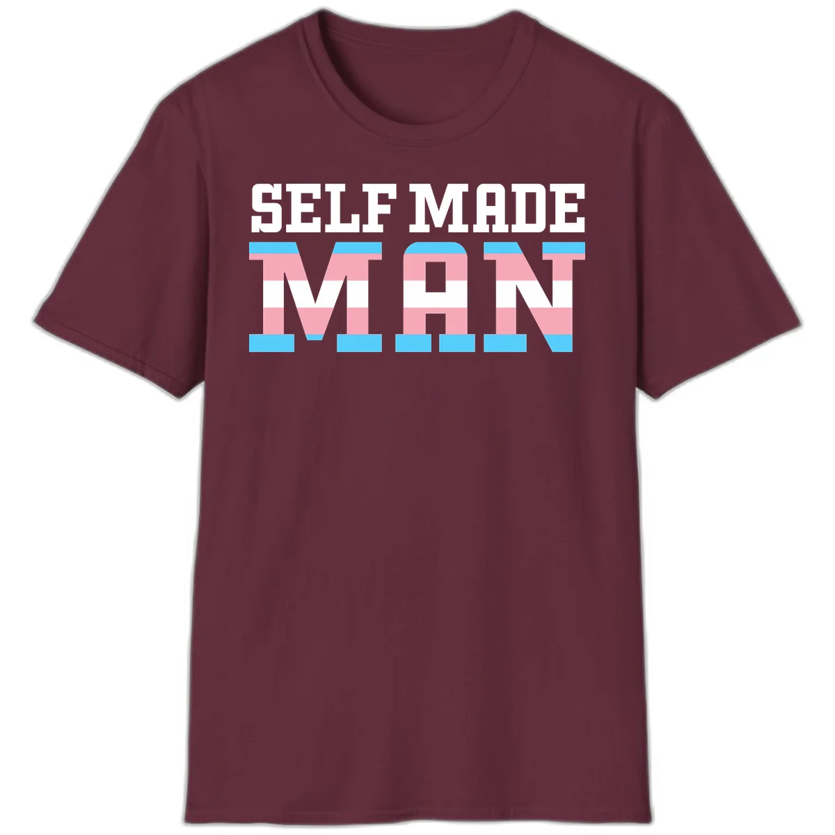 Bold 'Self Made' text filled with transgender pride flag stripes in blue, pink, and white on gray background in Maroon