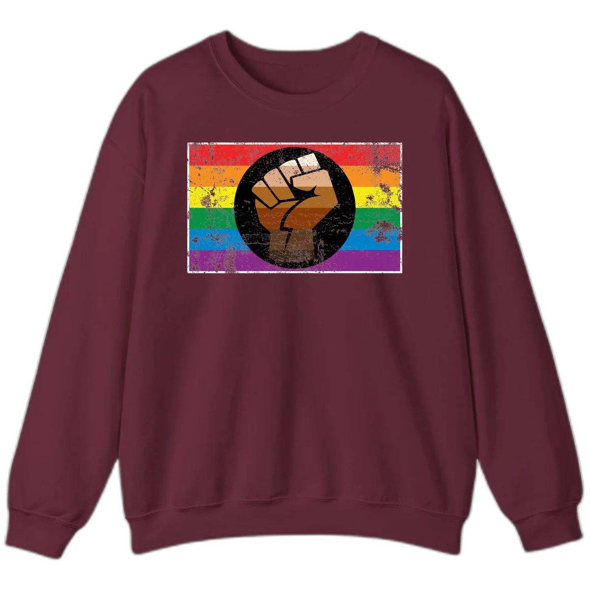 Distressed circular badge featuring a raised brown fist overlaid on a rainbow pride flag background, symbolizing LGBTQ+ solidarity and empowerment in Maroon