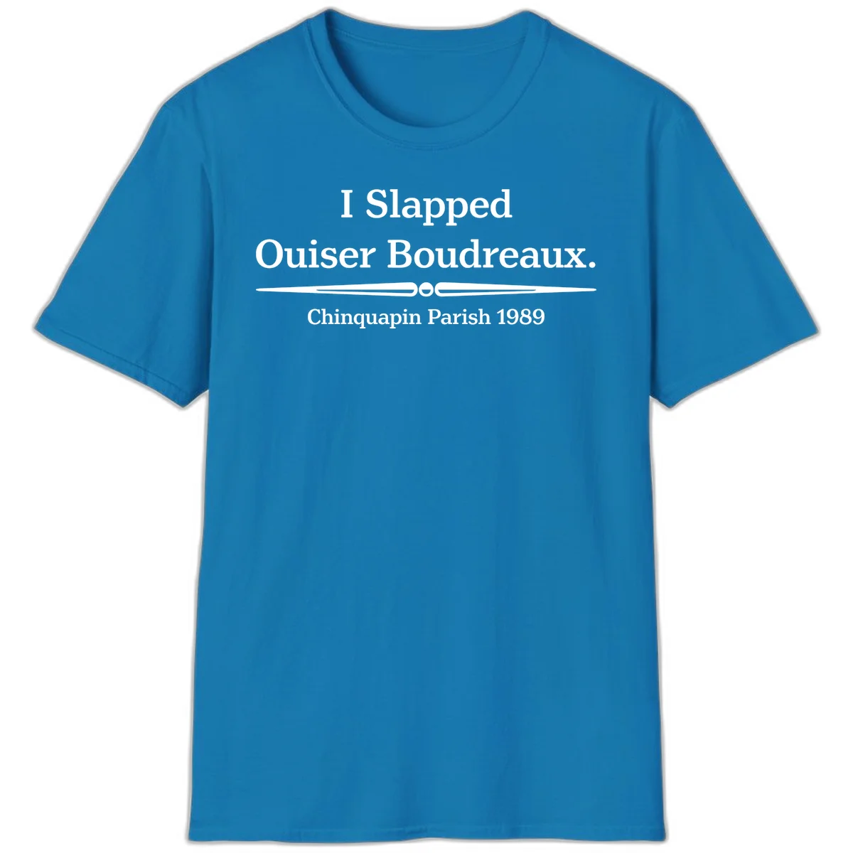 White text on gray background reading 'I Slapped Ouiser Boudreaux. Chinquapin Parish 1989' with decorative line divider in Sapphire